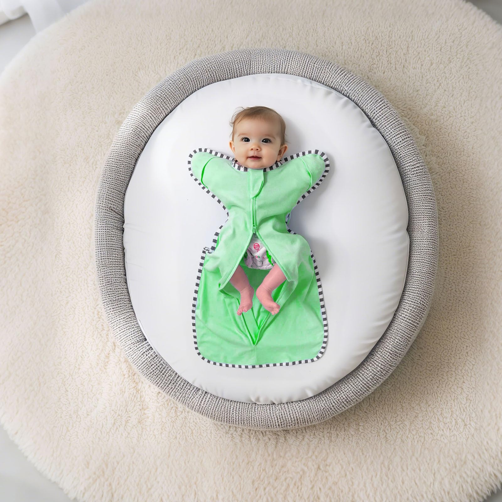 QUENNESS wearable swaddle worn by infant shows smooth transition to arms-free sleep.