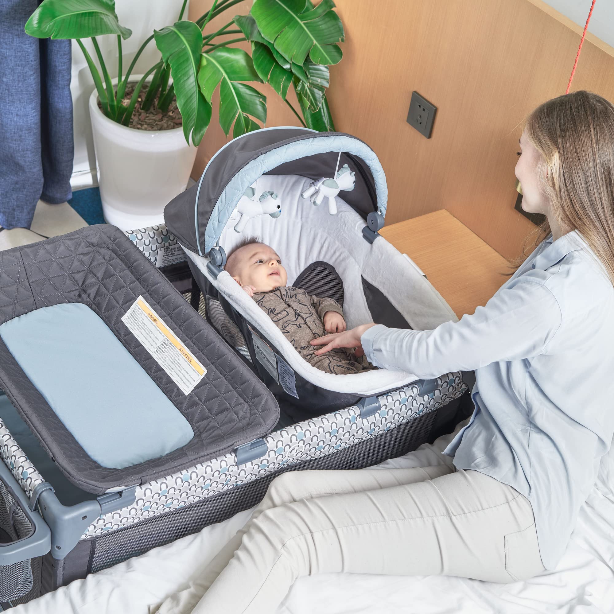 QUTANIX portable bassinet with mattress provides cozy sleep anywhere.