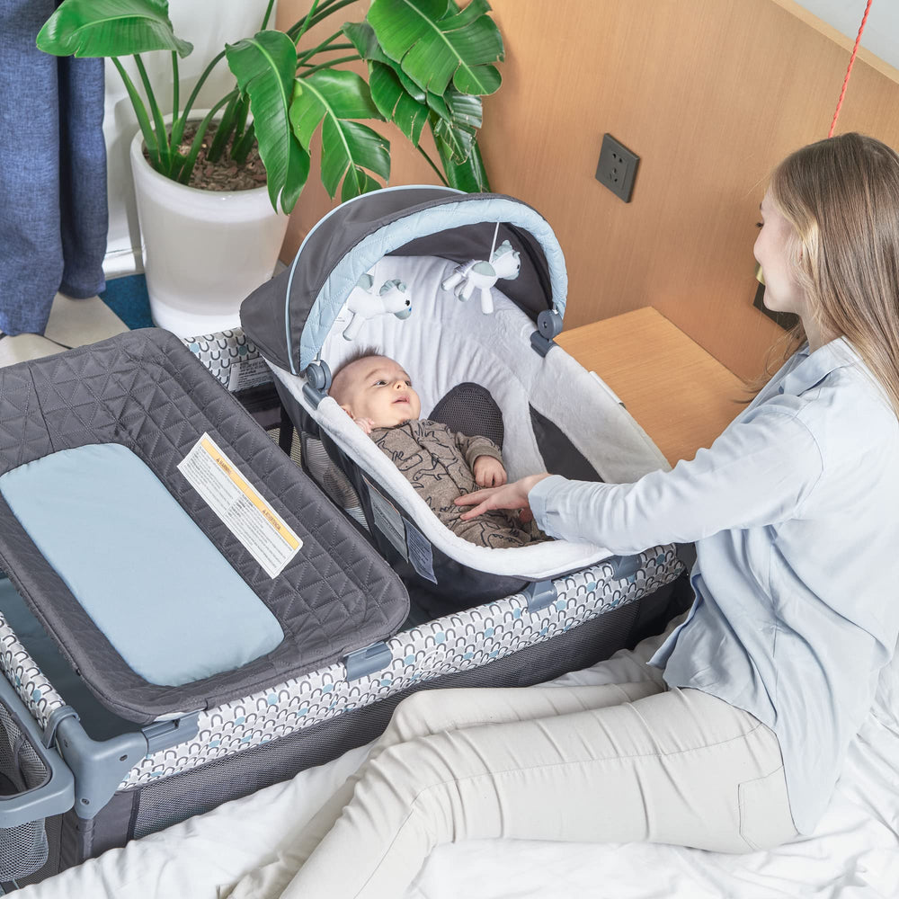 QUTANIX portable bassinet with mattress provides cozy sleep anywhere.