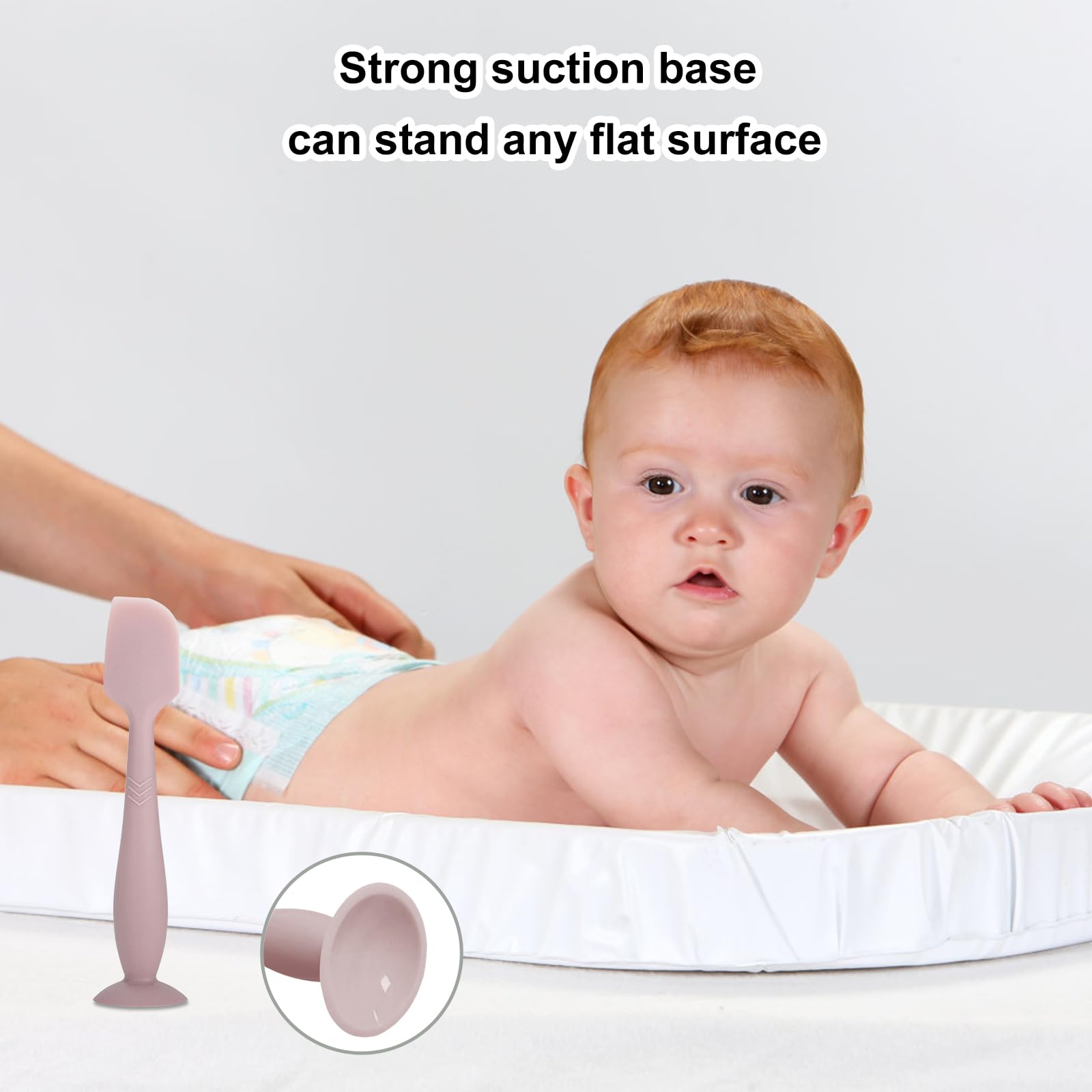 QYG diaper cream spatula suction base stands upright at changing table.
