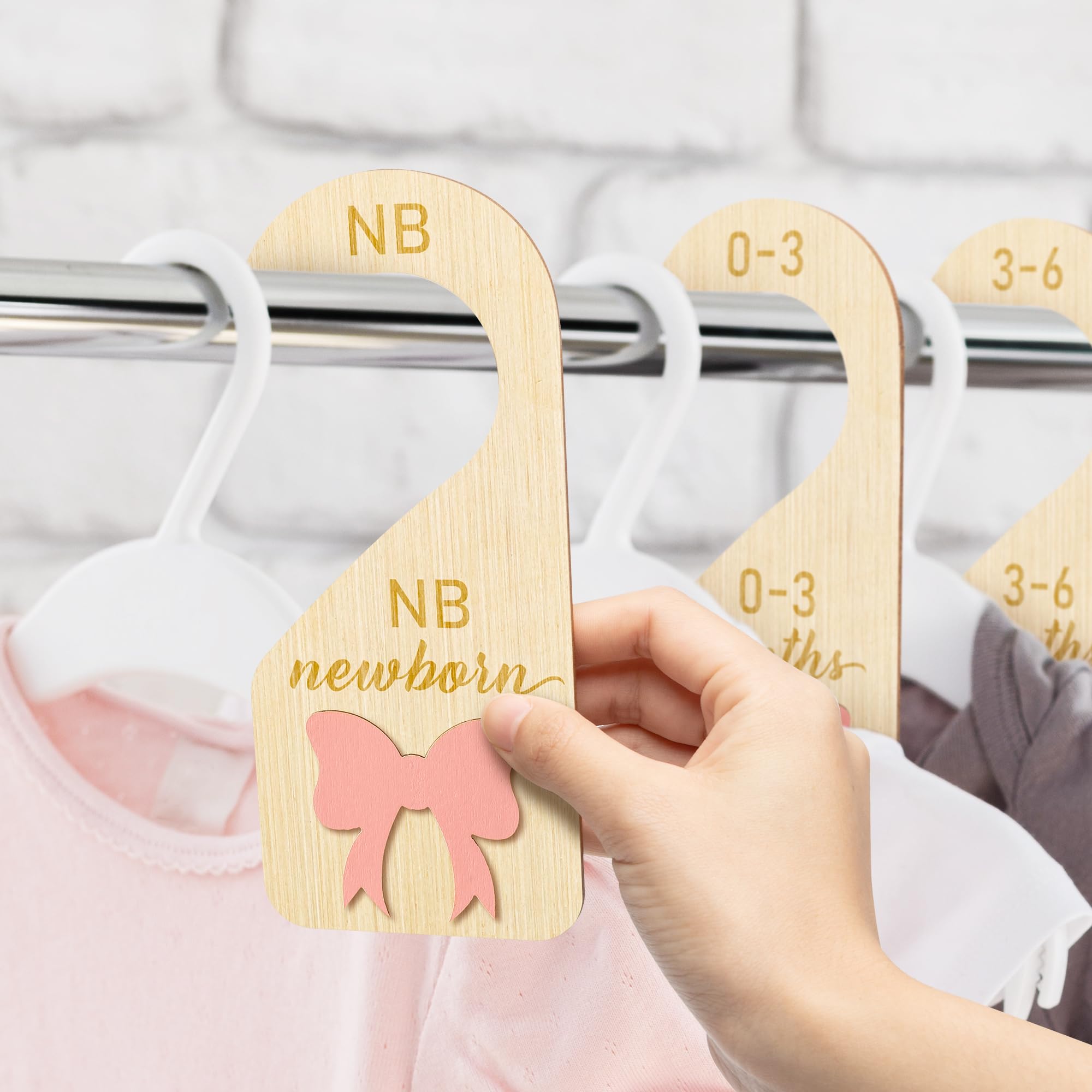 R HORSE pink bow detail enhances nursery decor while organizing outfits.
