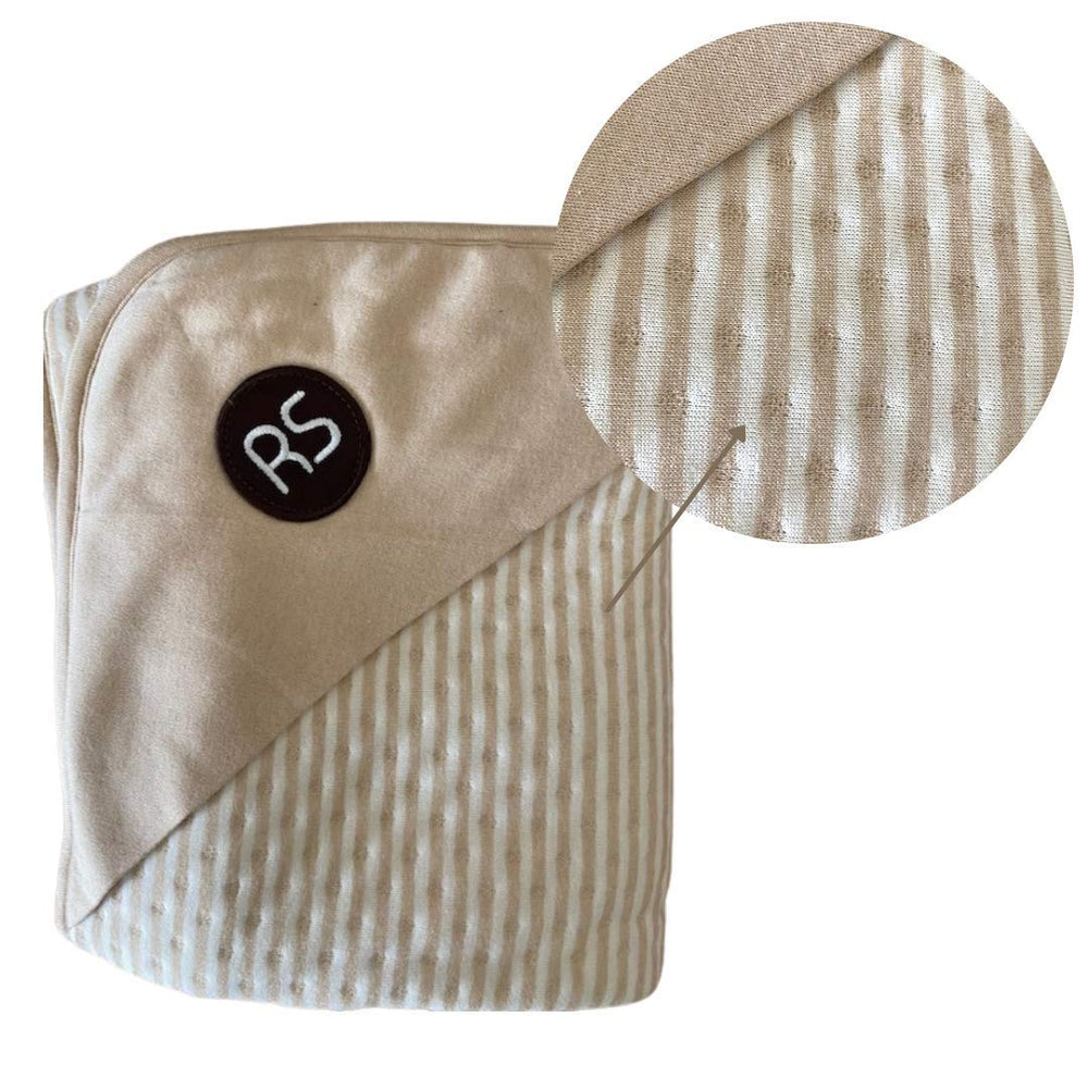Radia Smart cream blanket on sofa during relaxed screen time