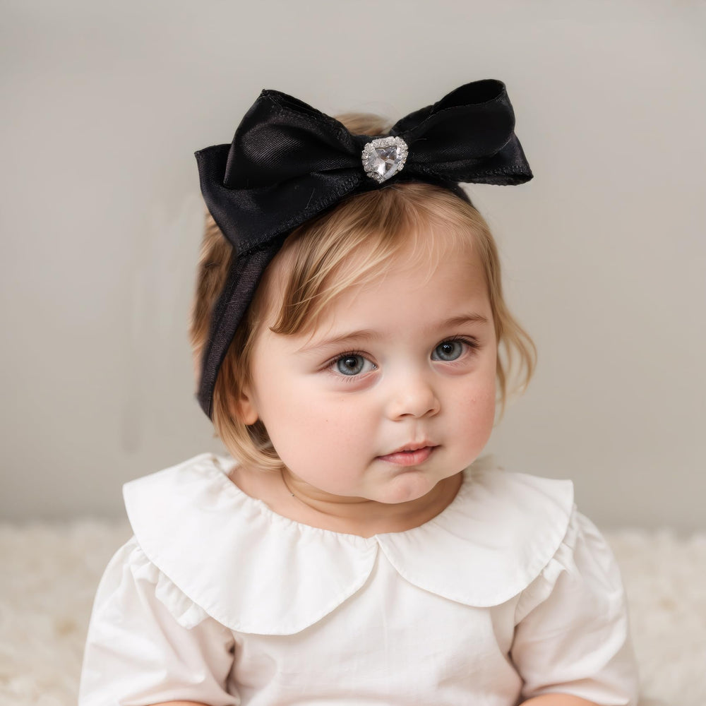 Rannyrena cream velvet gloss bow headband provides versatile everyday accessory.