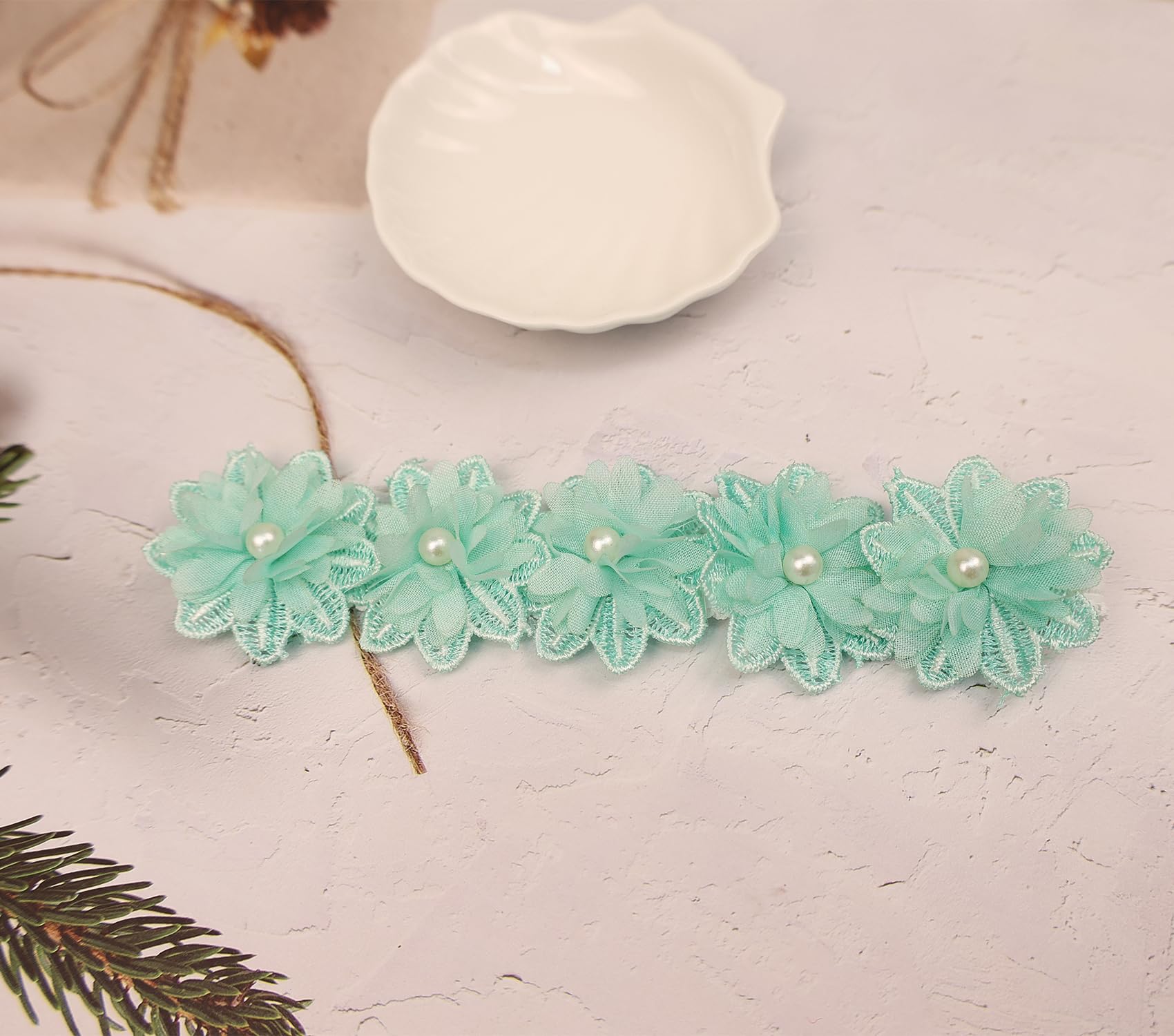 Rannyrena cyan floral design detail highlighting delicate lace and petals.