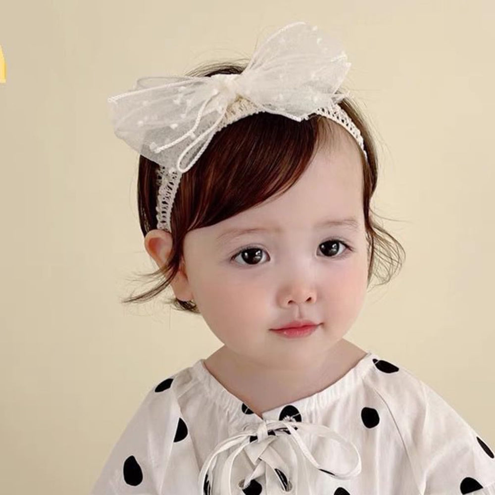 Rannyrena knotted bow ivory headband on baby for stylish look