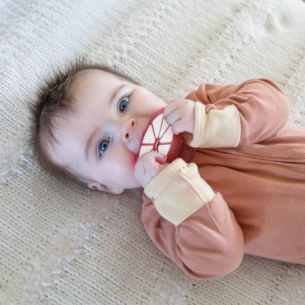 Relive baby teether grip close-up showing ergonomic design for motor skill development
