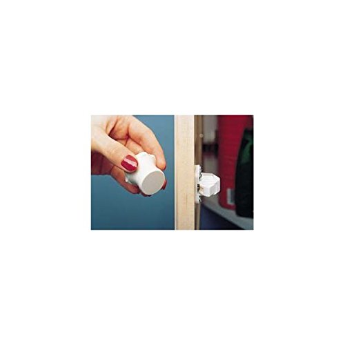 Rev-A-Shelf Tot Lok key in use on dense wood cabinet for easy access