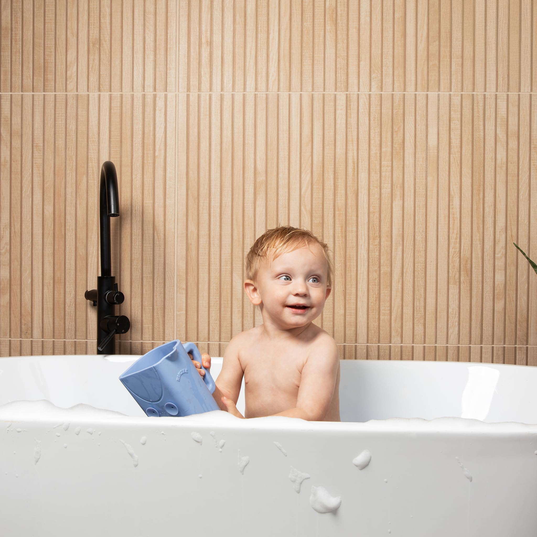 Rinzee kids learning tool promotes sensory play with stacking and popping on tiles.
