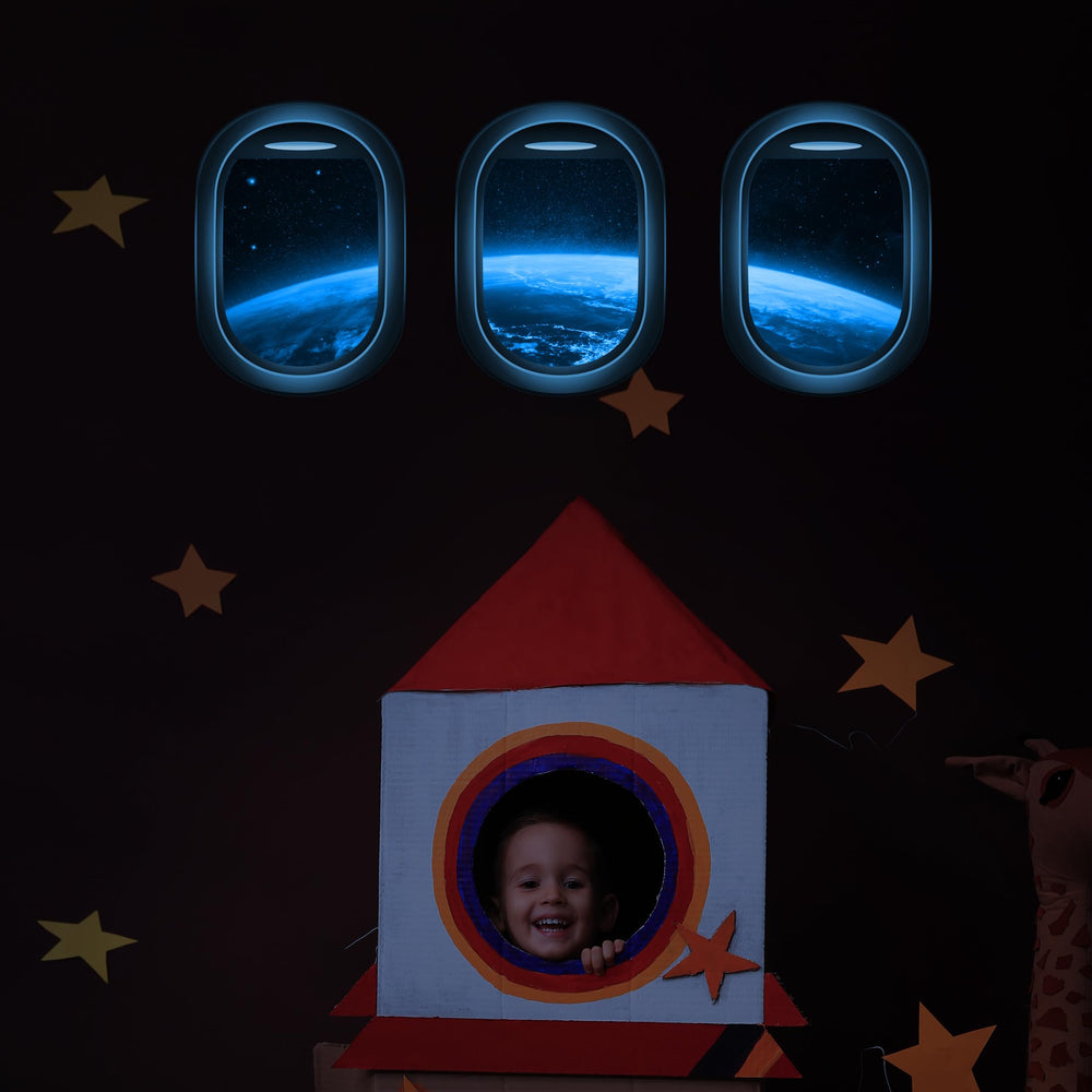 Robmoda glow-in-the-dark space decals illuminate walls for night-time play.