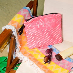 Rolling Nomad Tyvek pouch front pattern with radiant beach sunset design.