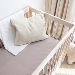 ROMY RO dual-layer muslin crib sheet highlights durability for lasting snug fit.