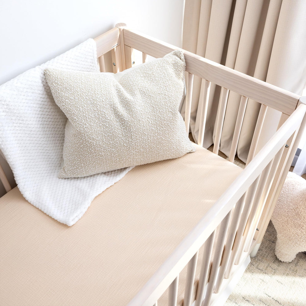 ROMY RO crib sheet in wheat with secure elastic edge for snug mattress cover.