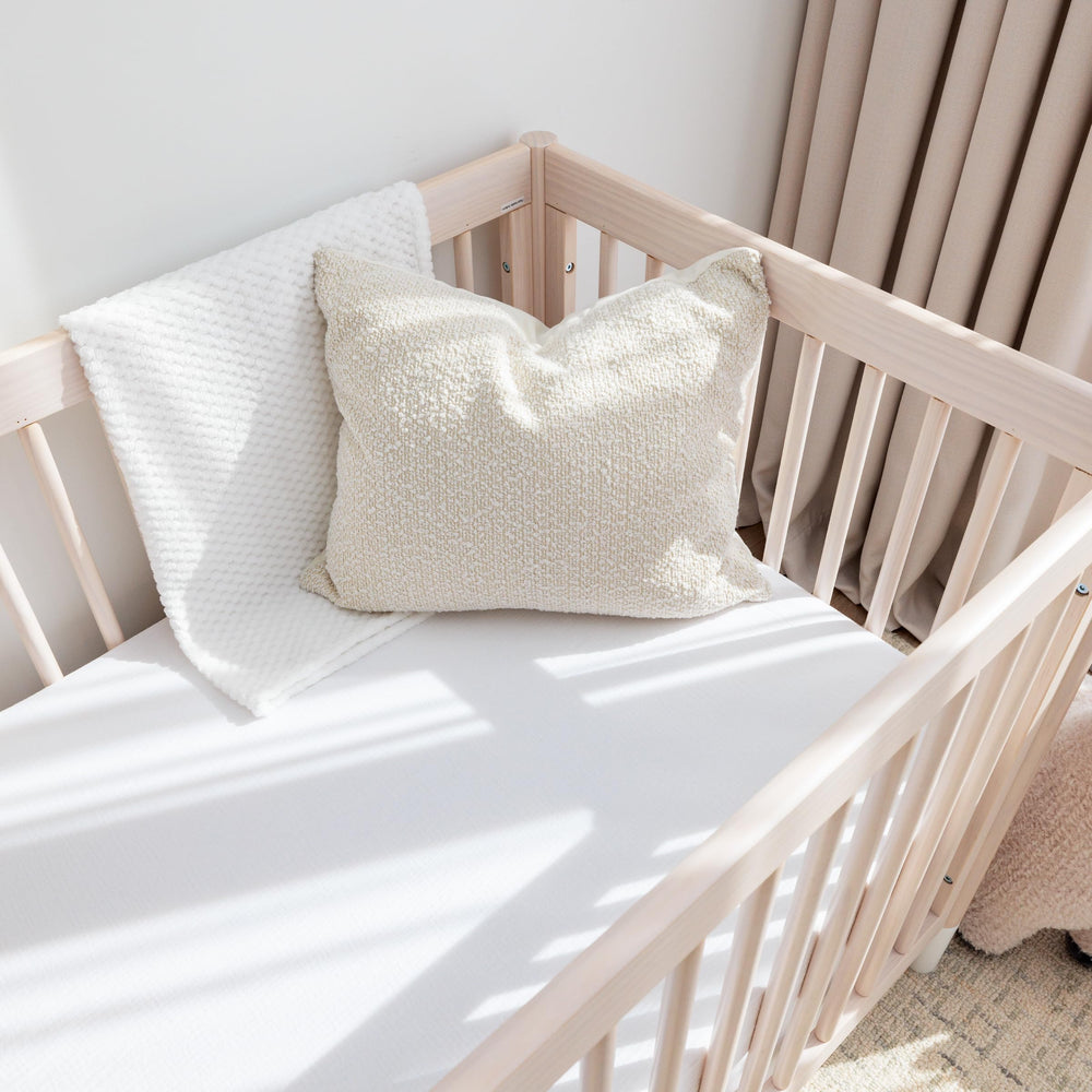 Romy Ro muslin crib sheets on standard crib mattress show a snug 28x52 fit