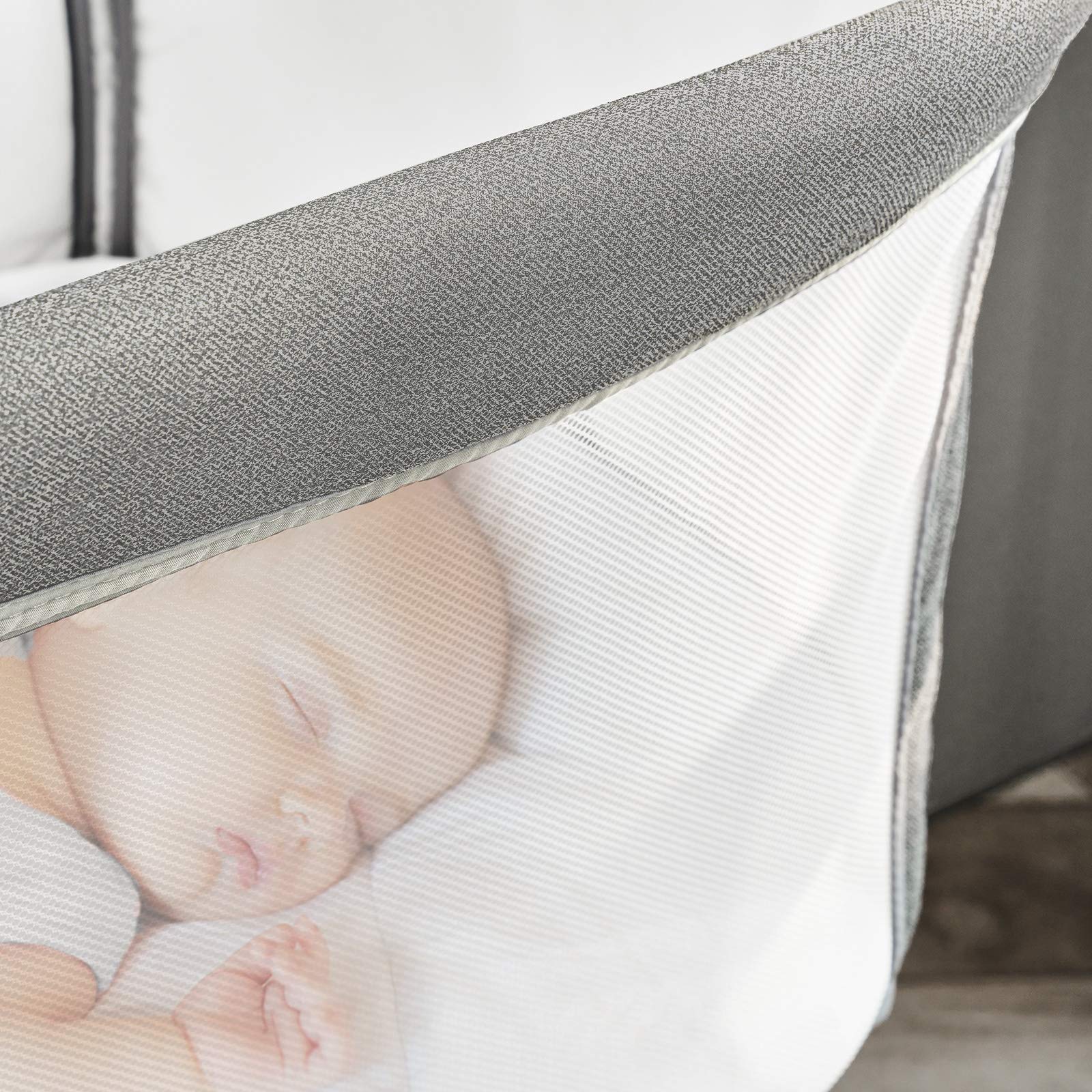 RONBEI Bassinet side panel lowered for quick soothing and checks.