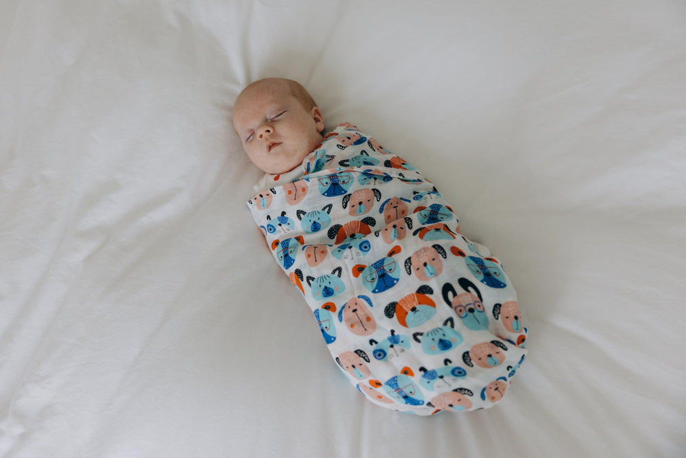 Roo and Bear pink dogs illustrations swaddle: playful pattern ideal for baby girls.