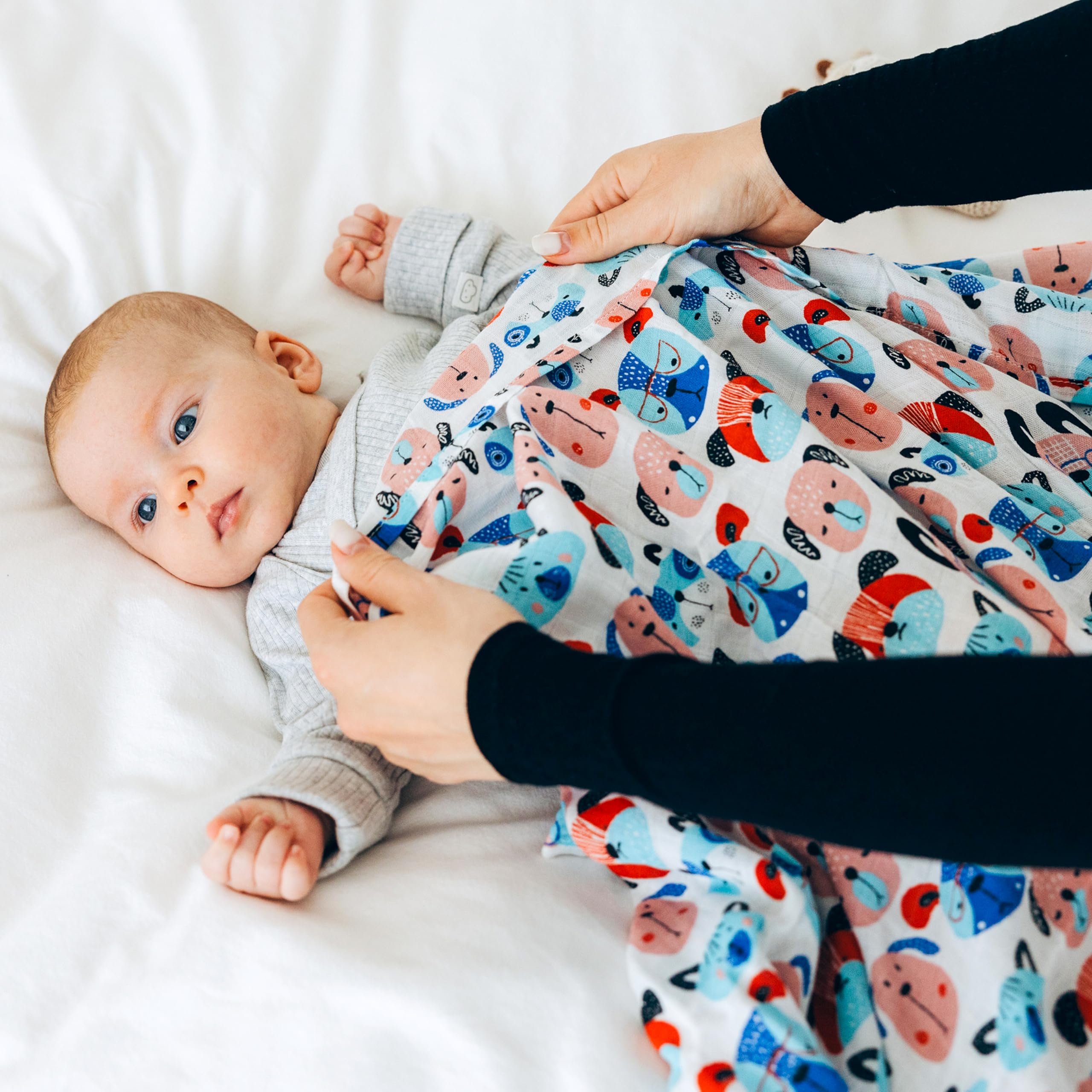 Roo and Bear swaddle used as nursery layer for cozy downtime and nursing.