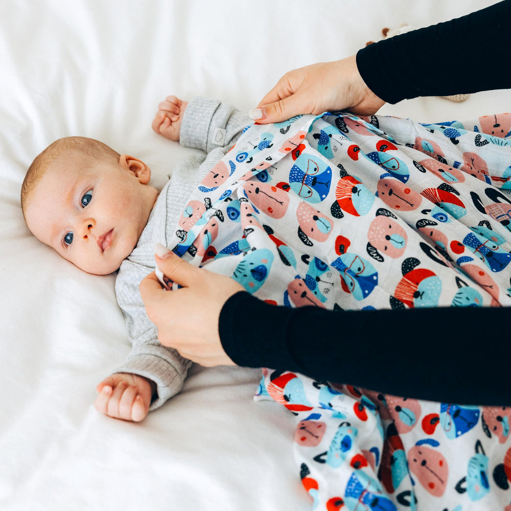 Roo and Bear swaddle used as nursery layer for cozy downtime and nursing.