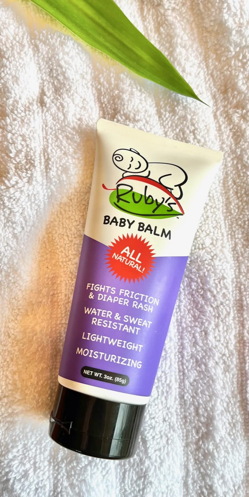 Ruby’s Lube balm applied to a baby’s bottom after diaper change for breathable protection.