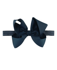 RuffleButts Girls Navy Bow Headband front view keeps hair neatly in place.