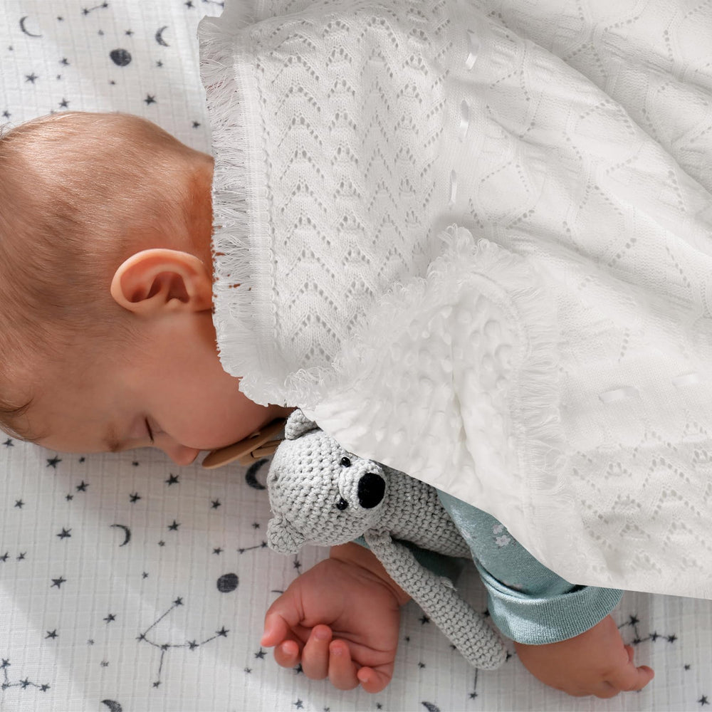 Runeaoys crochet receiving blanket with plush lining for newborn comfort.