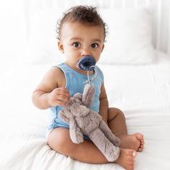 Baby holding the soft Cutie Cuddle Elephant, encouraging grip and motor skills.