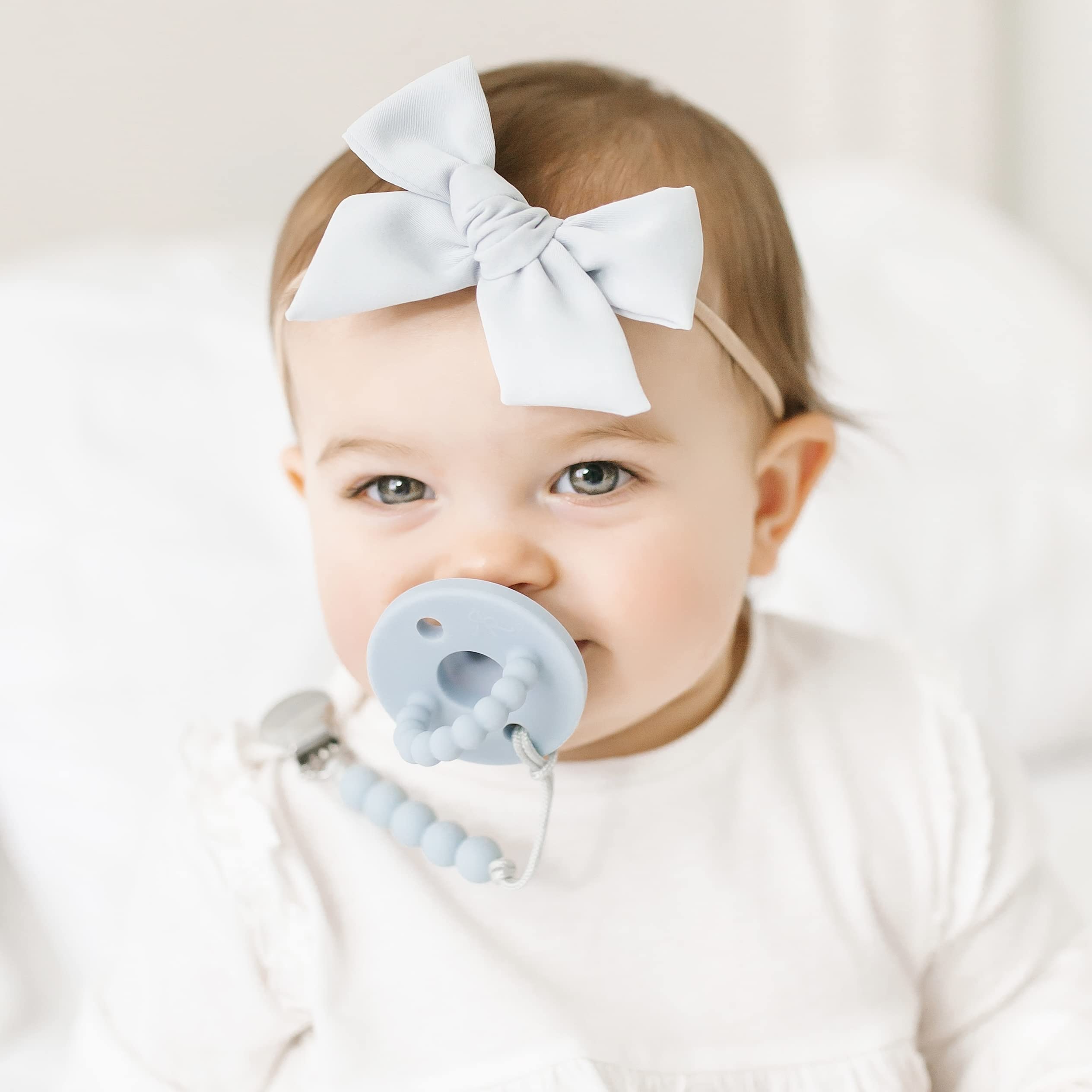 Ryan & Rose Cutie PAT blue in-use image showing combination pacifier and teether
