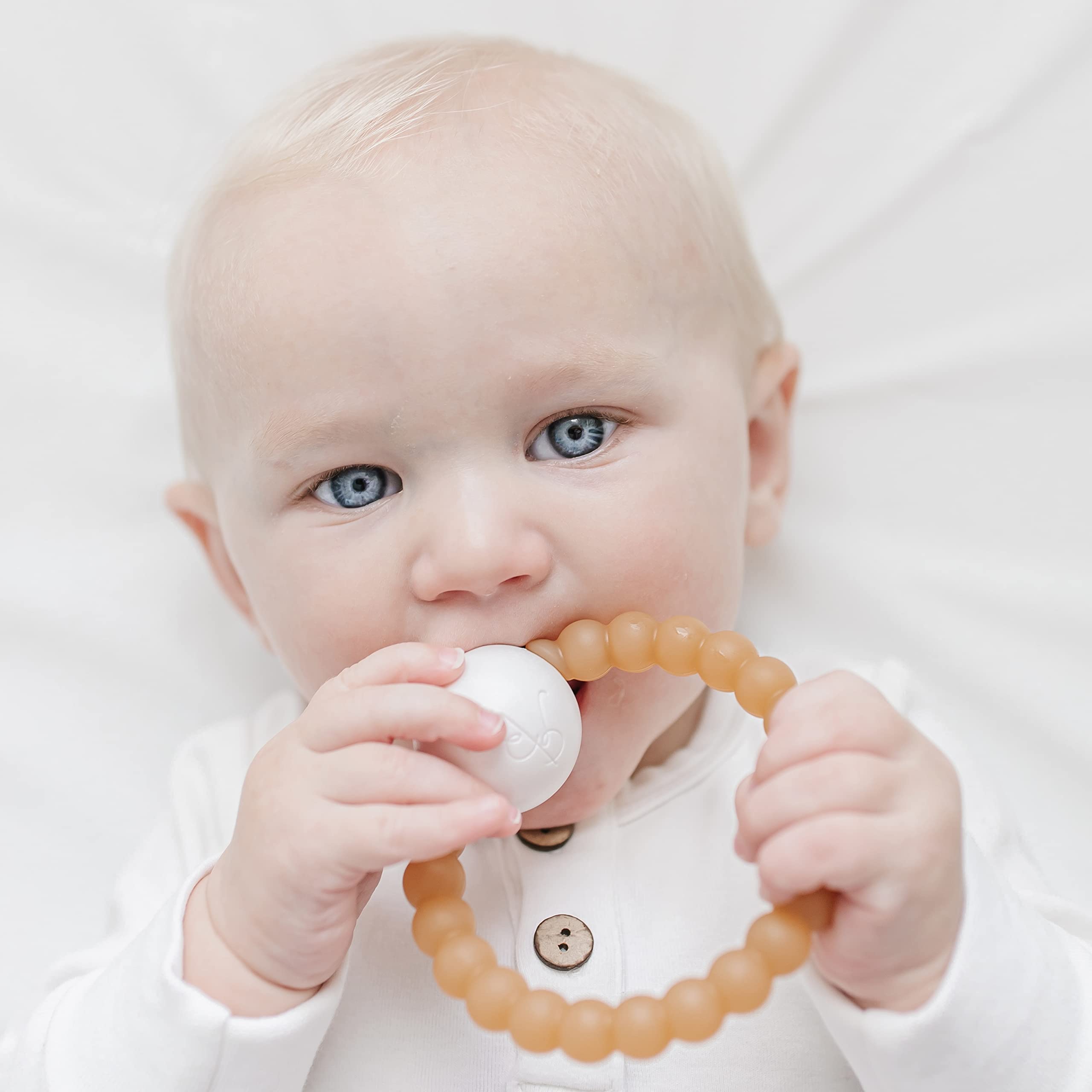Ryan & Rose Cutie Teether Rattle held in hand demonstrates easy grip for tiny fingers