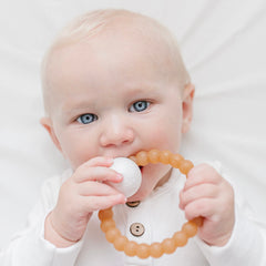 Ryan & Rose Cutie Teether Rattle held in hand demonstrates easy grip for tiny fingers
