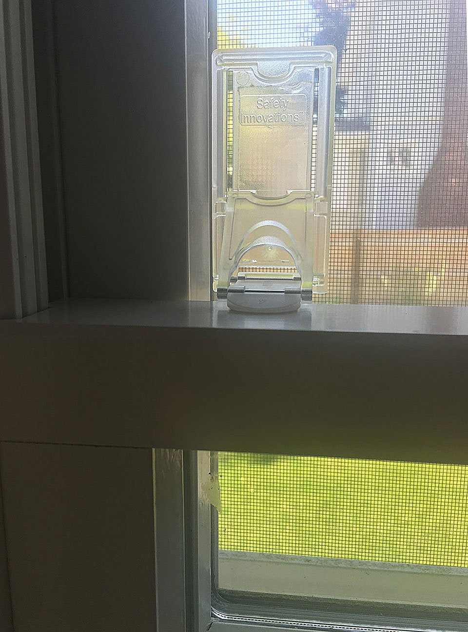 Safety Innovations sliding-door lock shown ready for use to secure a room