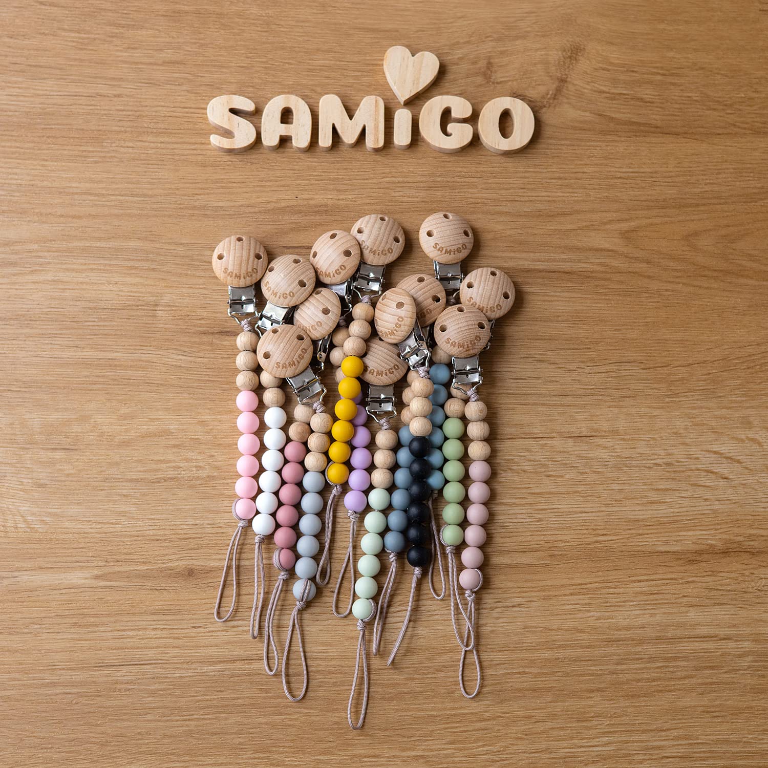 SAMiGO pacifier clips lightweight and comfortable on tiny outfits.