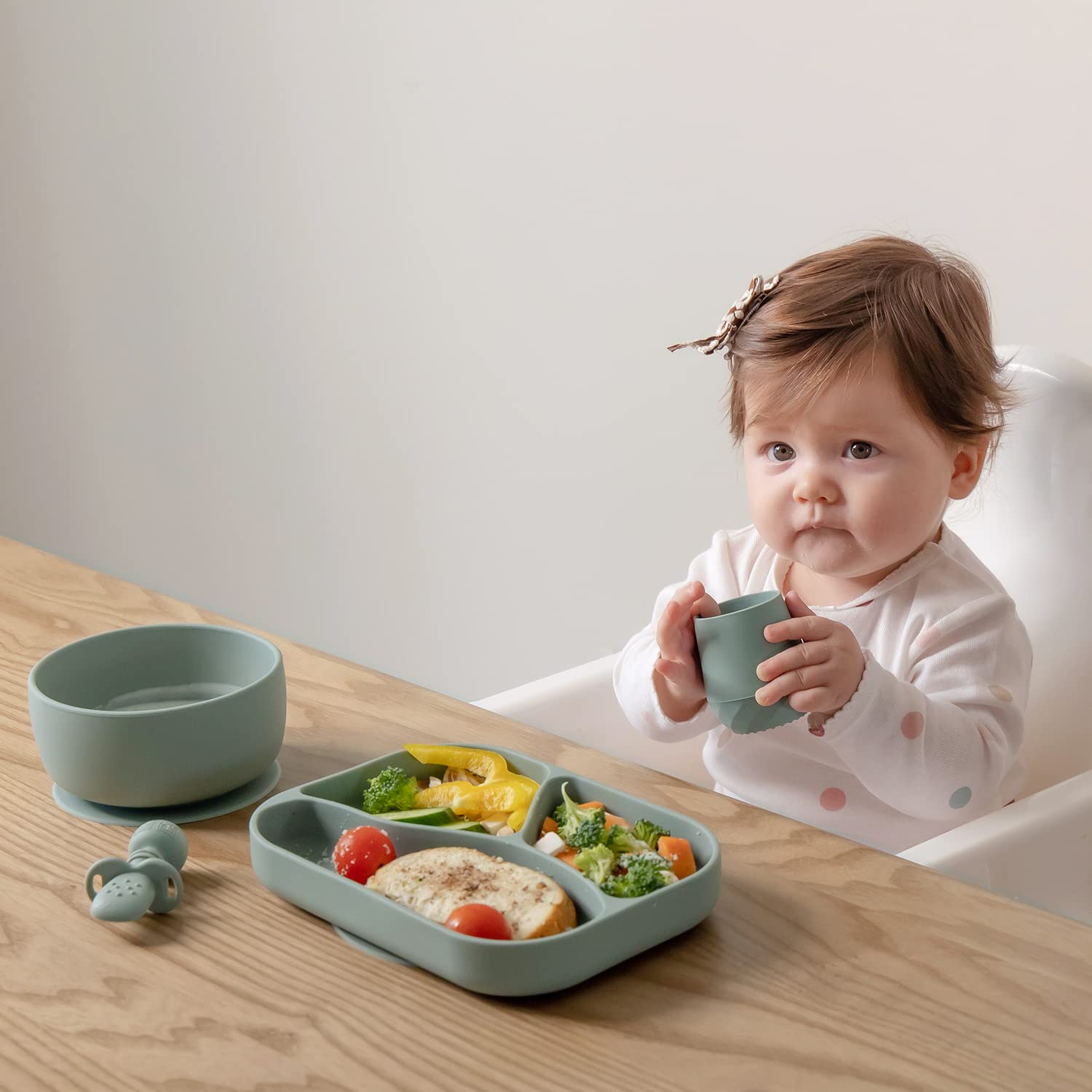 SAMiGO baby cup shows textured grip for secure handling by caregivers.