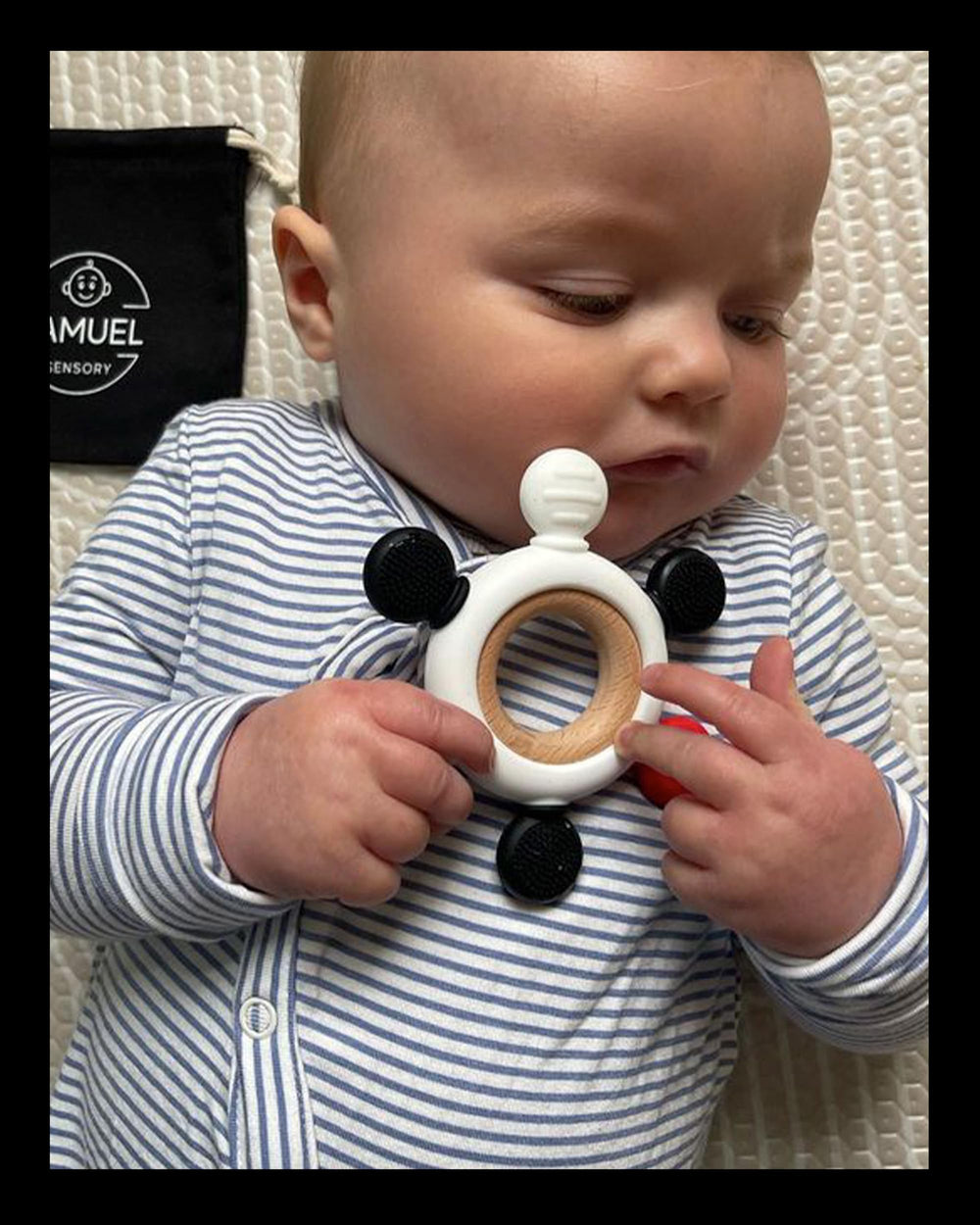 Samuel Sensory teether ring in pouch shows portable on-the-go design.
