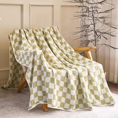 SANACYNA crib nursery scene with green grid blanket for all-season use.
