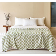 SANACYNA 100% cotton muslin blanket close-up of green grid texture for breathable warmth.