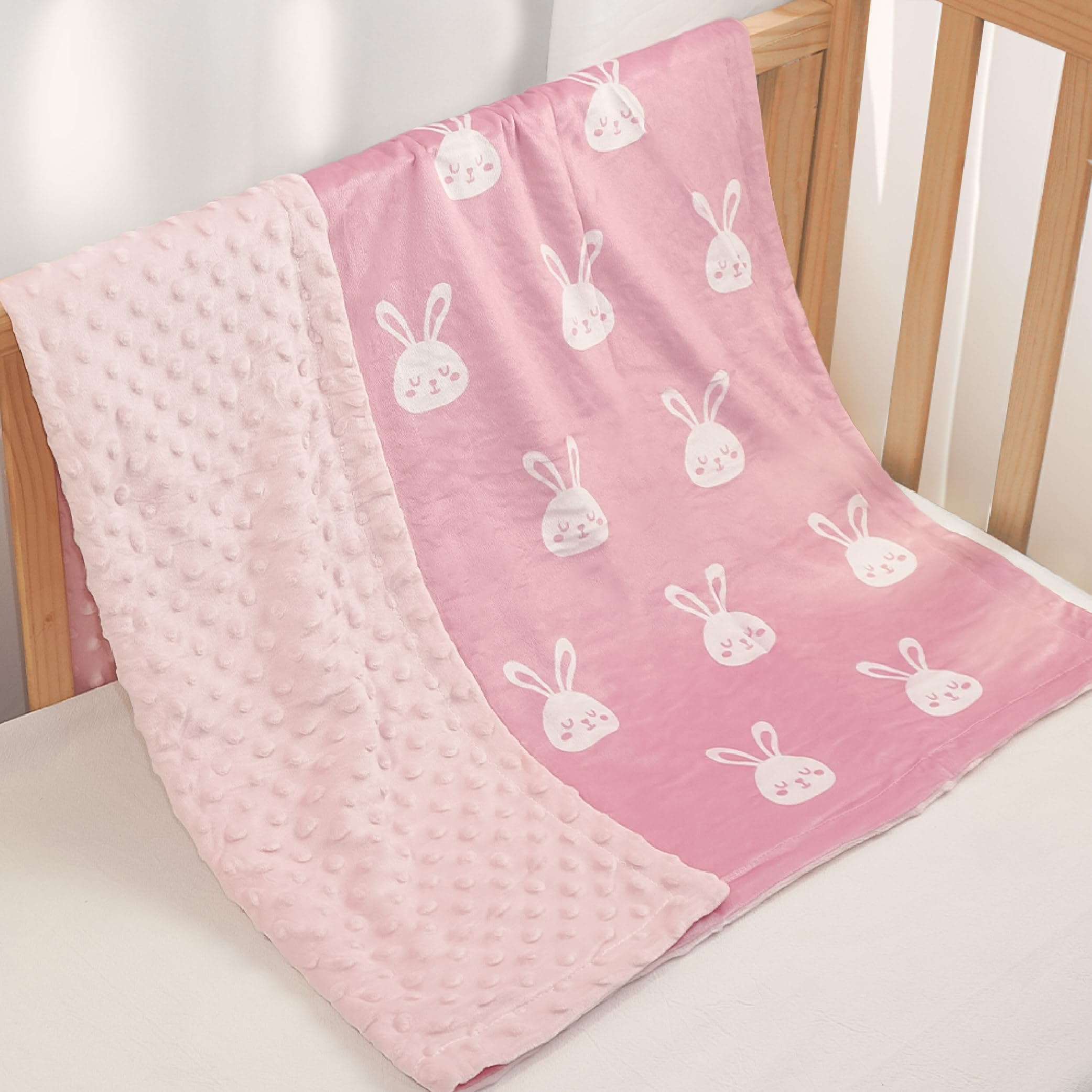SANDJEST Rabbit Minky blanket laid on bed creates a soft sleep surface.