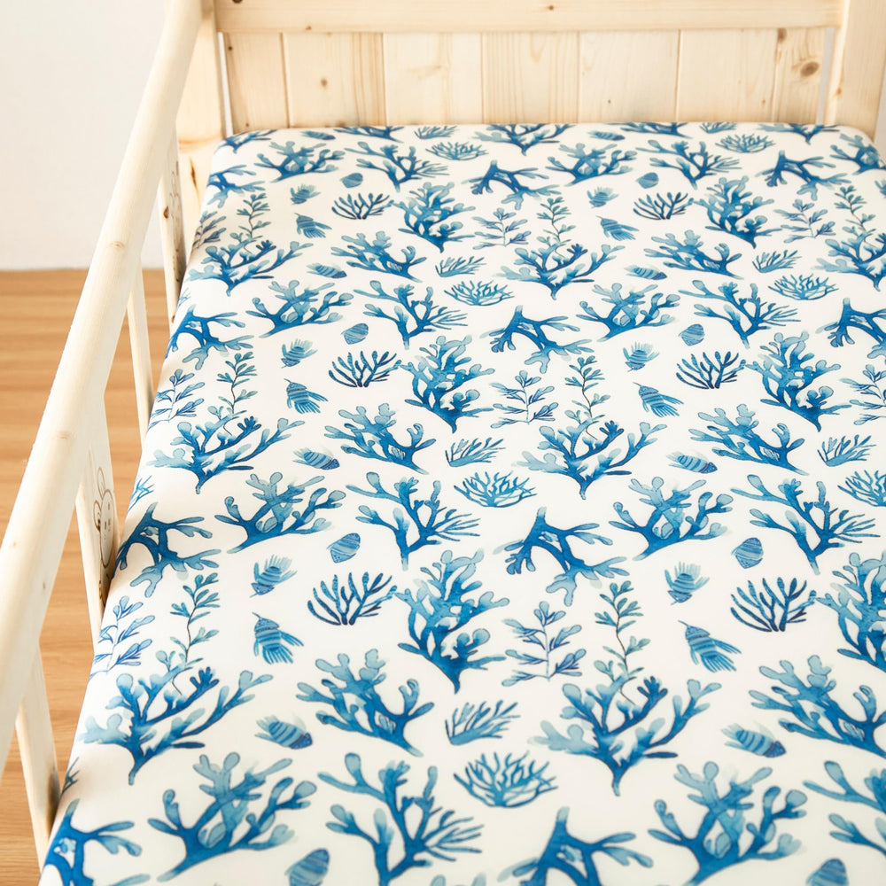 SDIII ocean styling pairs with navy and white nursery decor.
