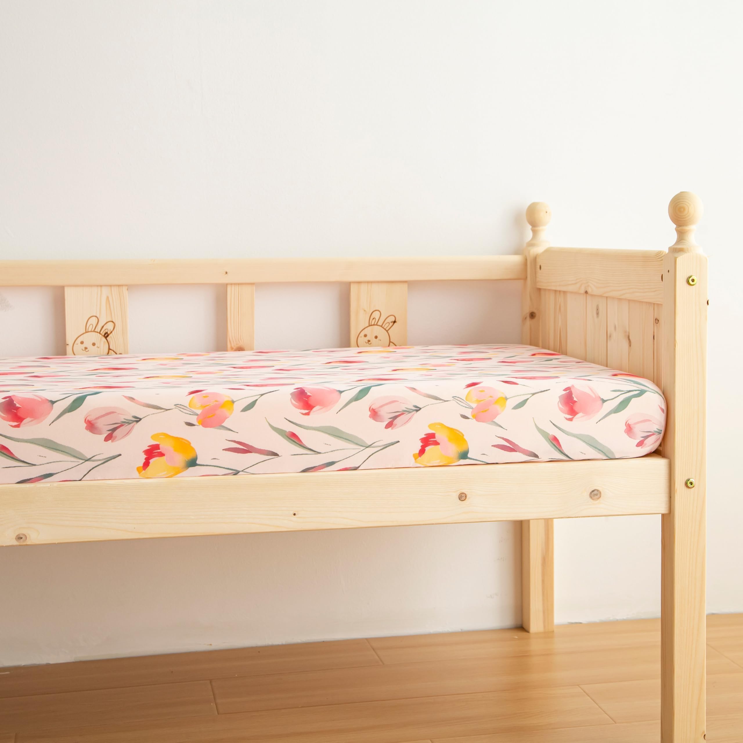 SDIII pink floral crib sheets neatly folded to emphasize quality and easy care.