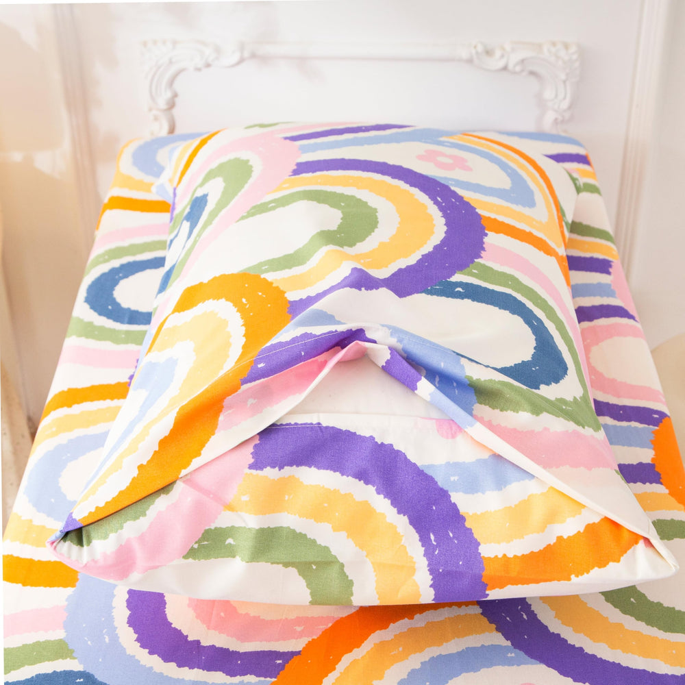 SDIII rainbow bedding on toddler bed — easy care for parents.