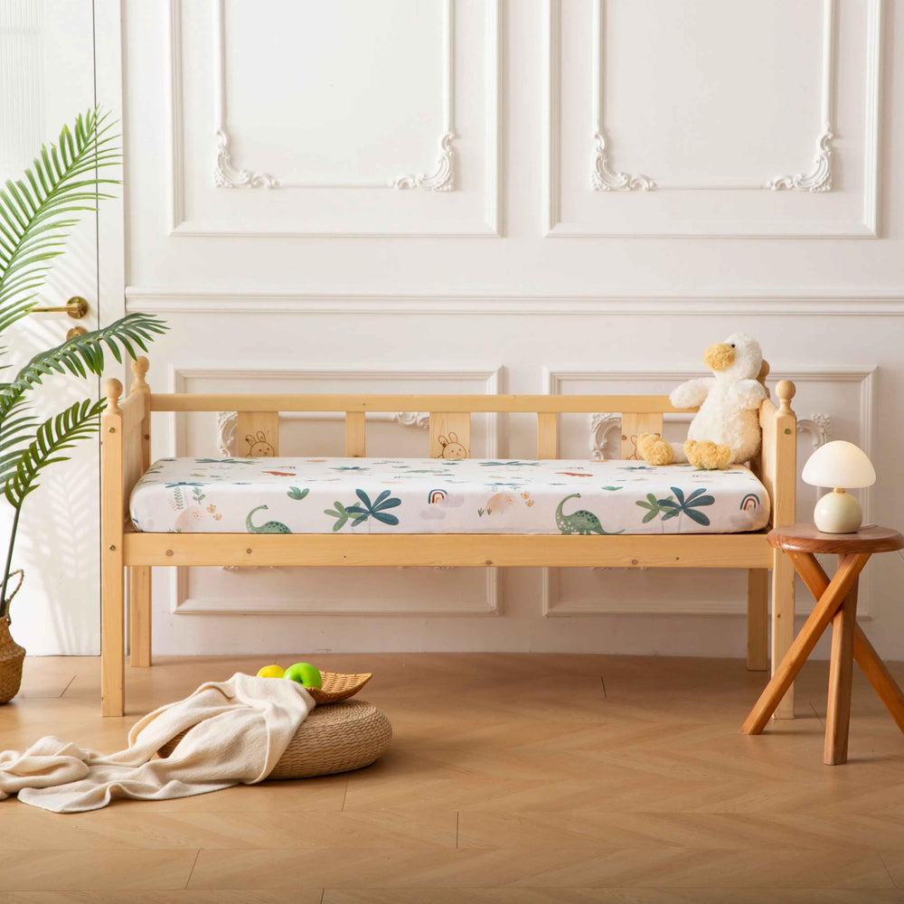 SDY Jersey Dinosaur crib sheet in nap-time scene with baby