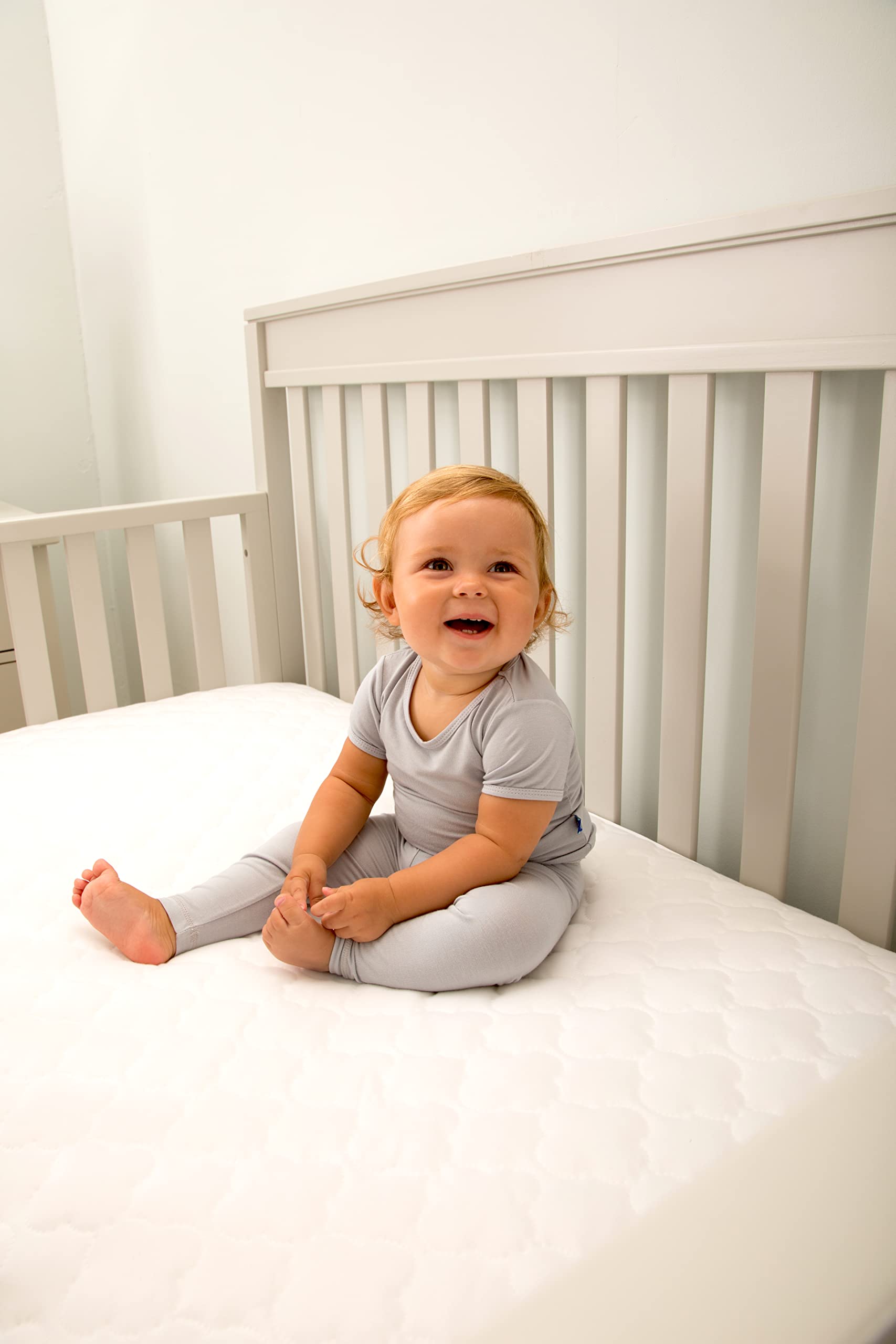 SEALY BABY white crib and toddler bed cover rendered for versatile use.
