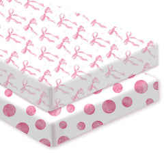 Sel Natural pink bow crib sheet on crib showing secure fit for naps