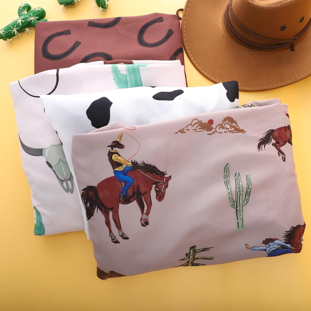 Sel Natural nursery cowboy bedding print completes a coordinated boys' nursery theme.