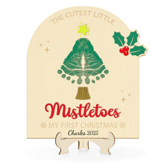 Sereliy baby's first Christmas footprint sign on wood, perfect keepsake for photos.