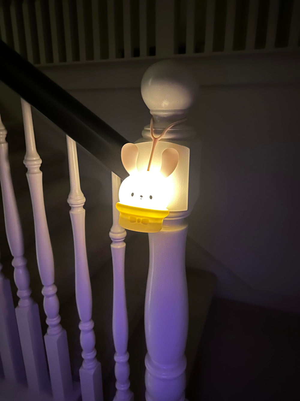 ShaArkMango portable night light with hanging strap for versatile placement.