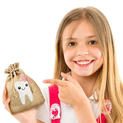 Shappy tooth fairy bag sits beside a pillow creating a magical bedtime moment.