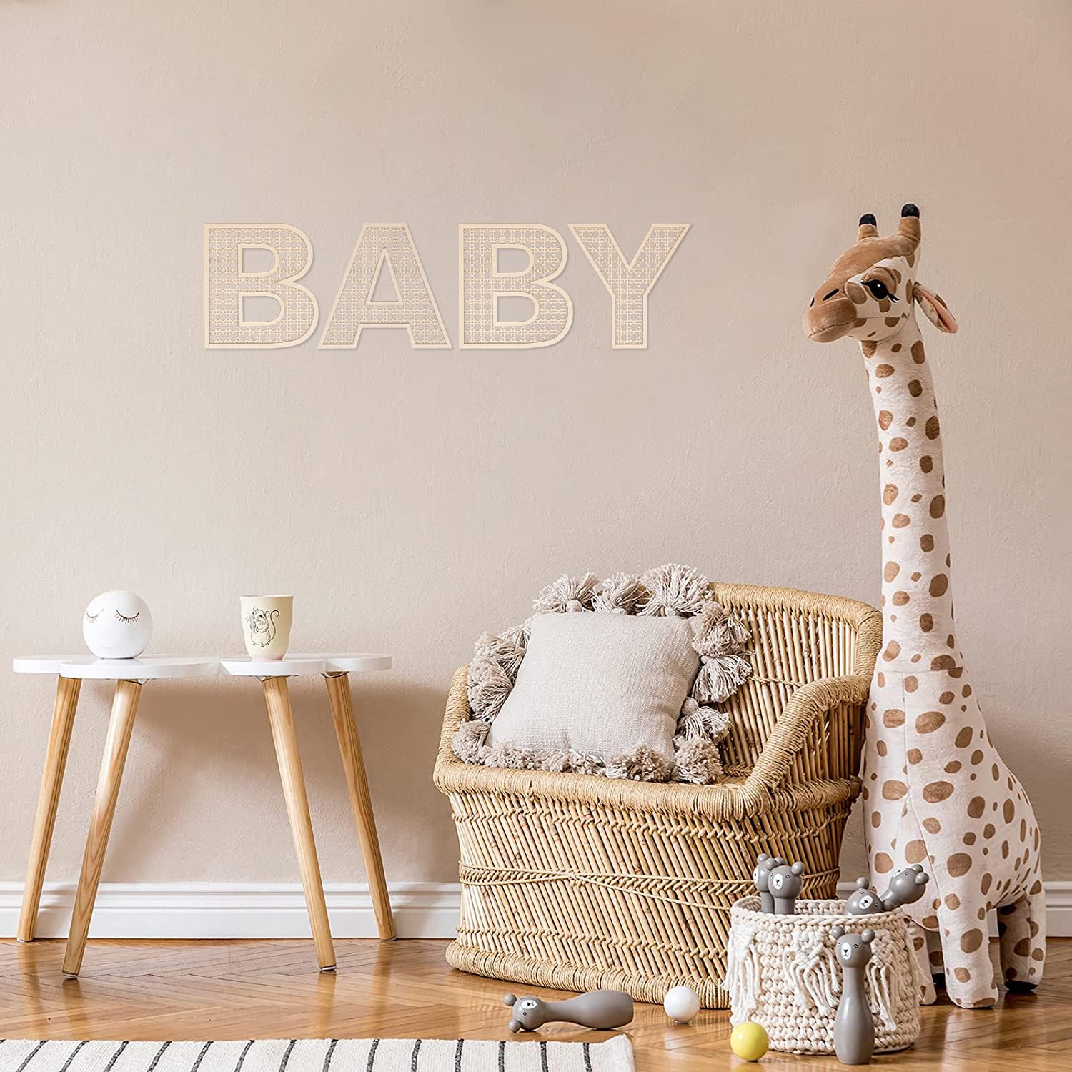 Boho nursery decor with She Love wooden rattan letters in a cozy setting.
