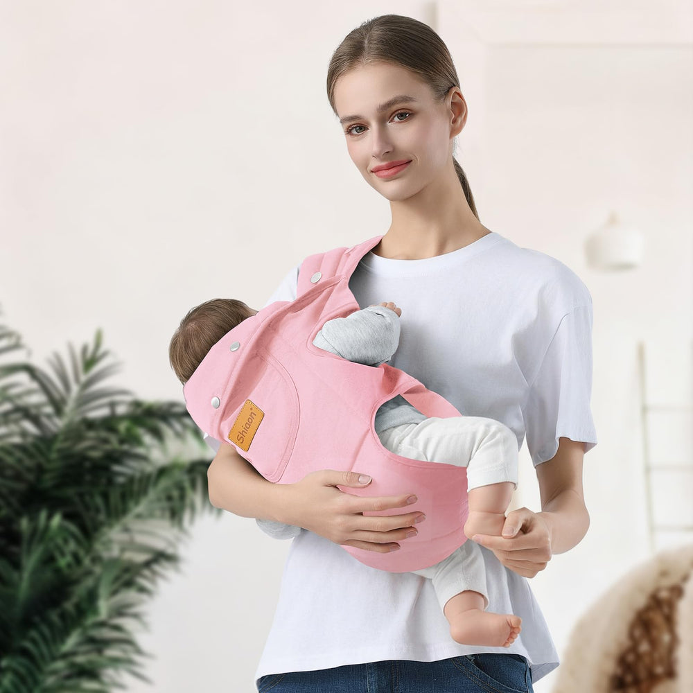 Shiaon pink baby carrier, in-use outdoors; convenient hands-free activity.