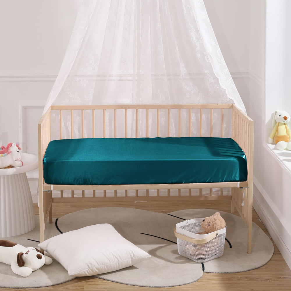 SiinvdaBZX satin crib sheets shown on playard compatible with most brands.