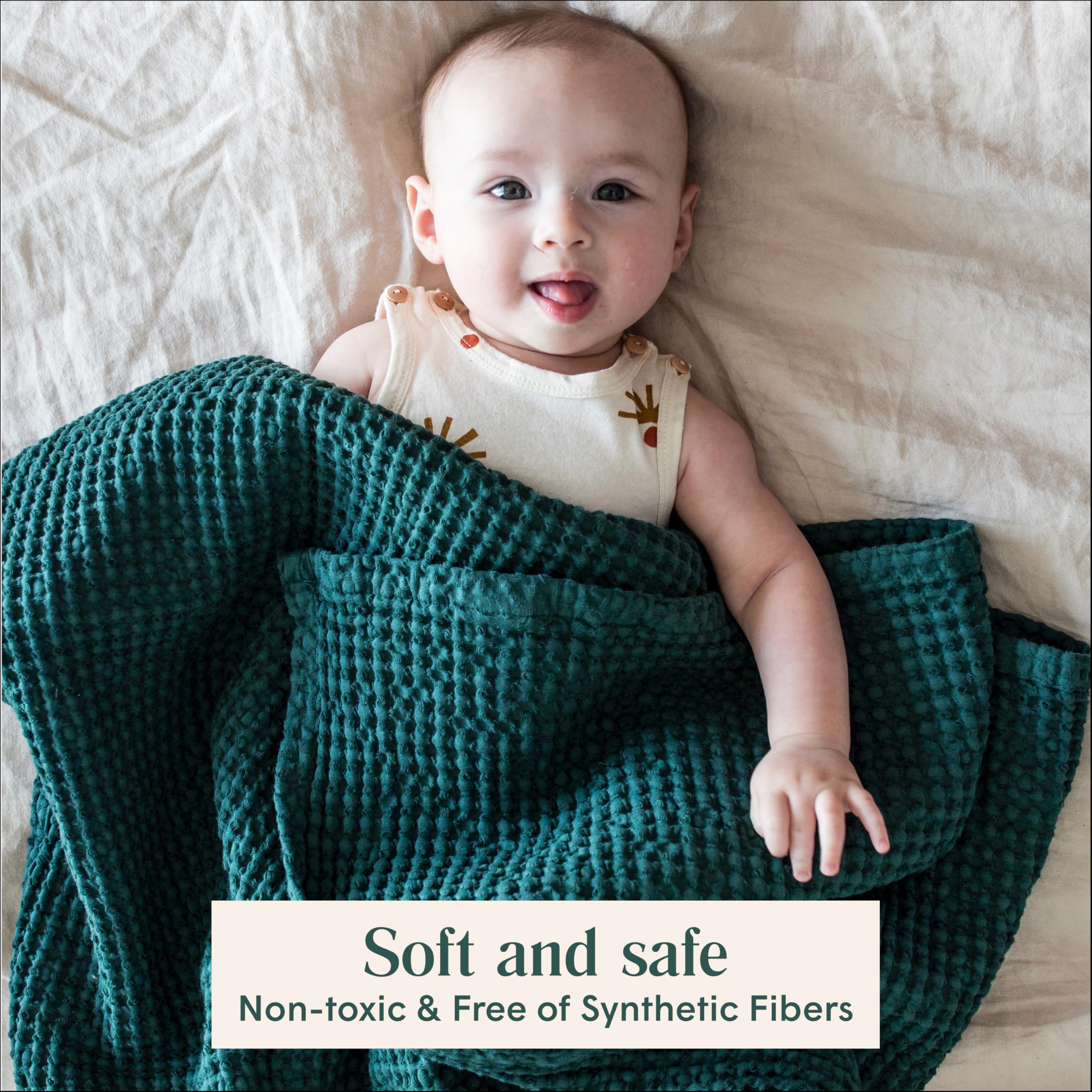 Simka Rose waffle baby blanket on crib, neutral color matching any nursery.