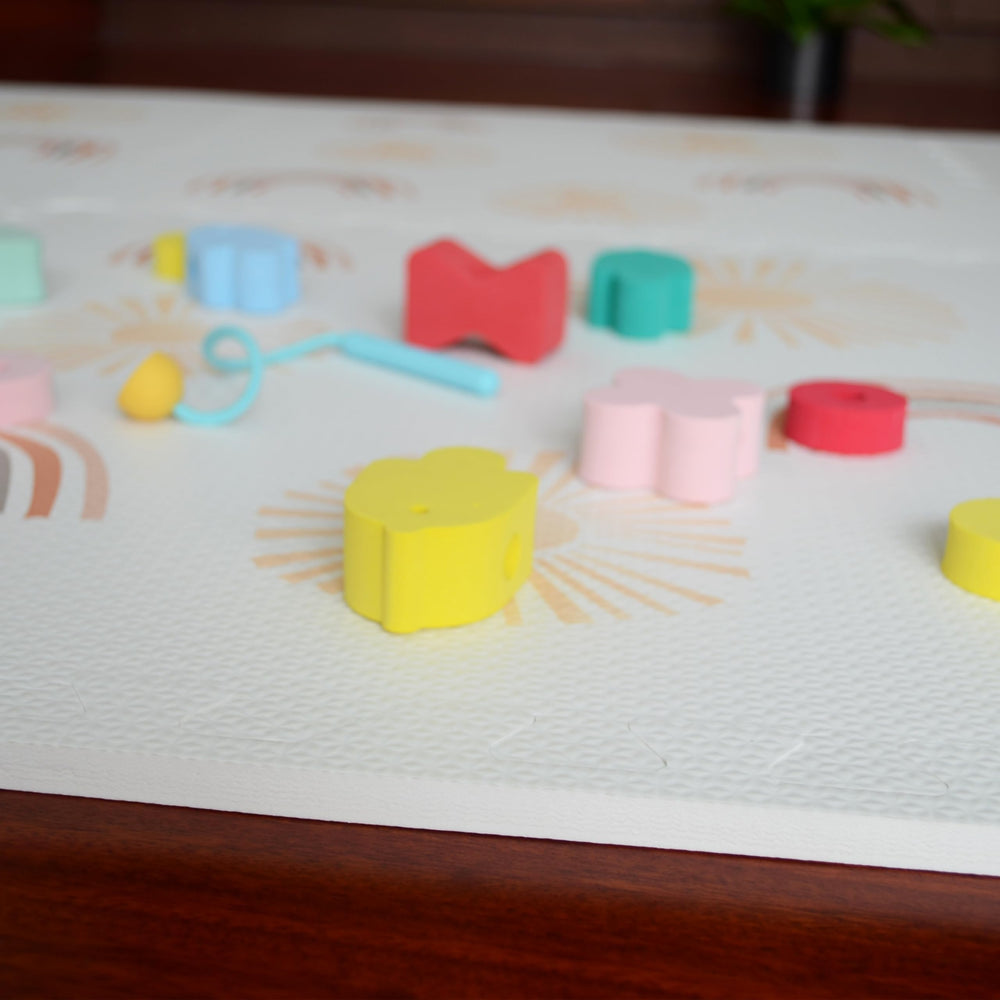 Simple Kid Co baby and toddler playing crawl and learn on a soft surface.